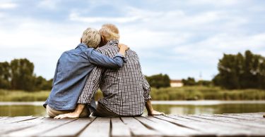 retired couple sitting on dock