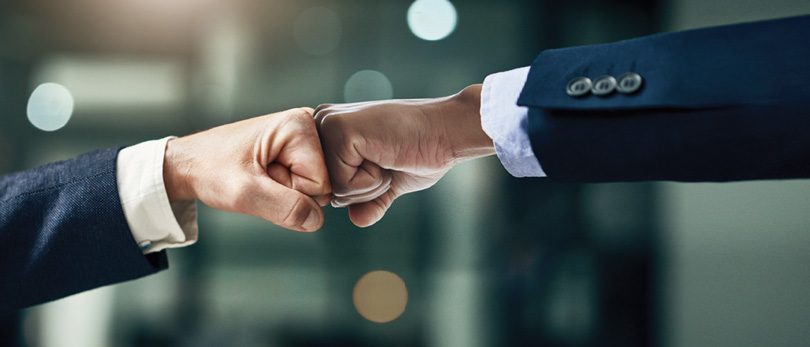 two people fist bumping