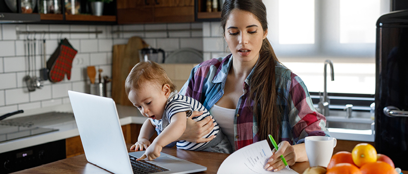 woman working while holding baby