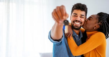 man and woman embracing holding keys