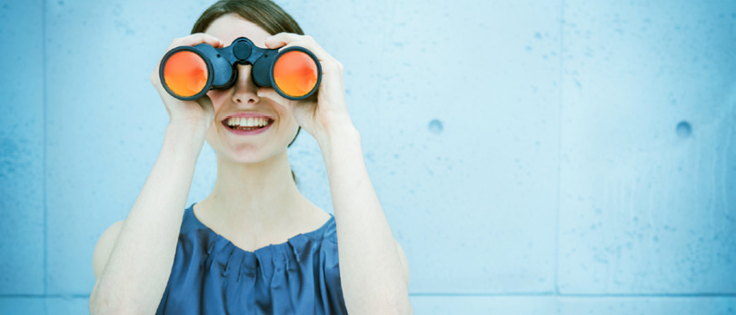 woman looking through binocculars