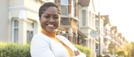 woman posing in front of real estate