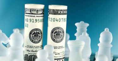 dollar bills as chess pieces