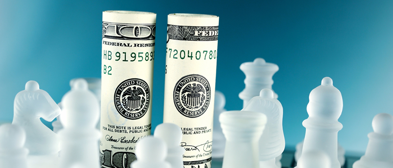 dollar bills as chess pieces