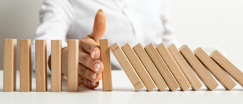 hand stopping wood blocks from falling