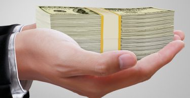 hand holding stack of money