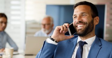 man talking on cell phone smiling