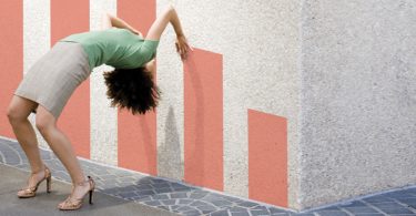 woman bending over against wall graph