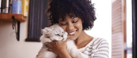 woman cuddling cat
