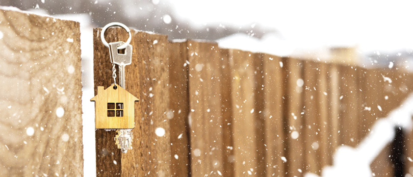 fence with birdhouse in winter