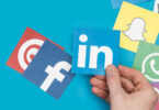 social media icons with LinkedIn held by hand
