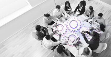 people sitting around a cog-based table