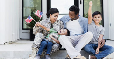 military family sitting on steps