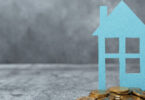 house with coins below it