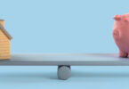 seesaw with house and piggy bank on either side
