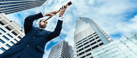 man in city using scope to look outward