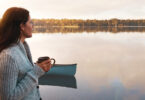 woman drinking coffee by lake