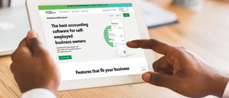 fingers touching tablet with financial app