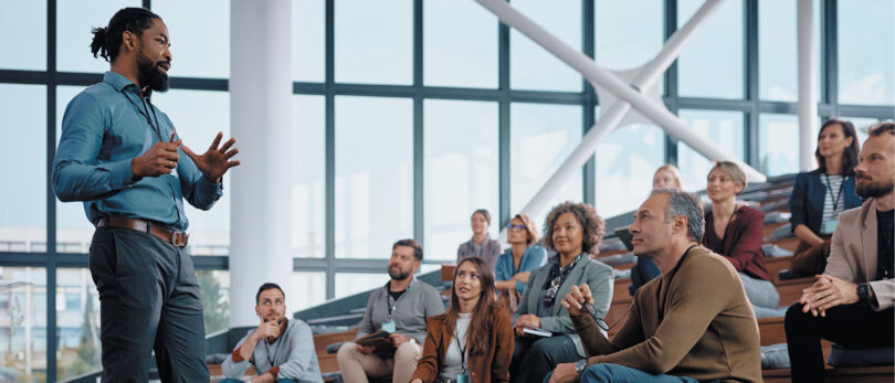 man presenting in front of audience