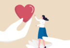 Illustration of woman standing on hand reaching for heart