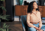 Woman meditating in her living room