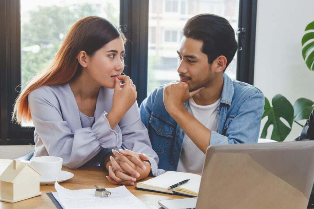 Buyers looking thoughtfully at housing market data during a consultation