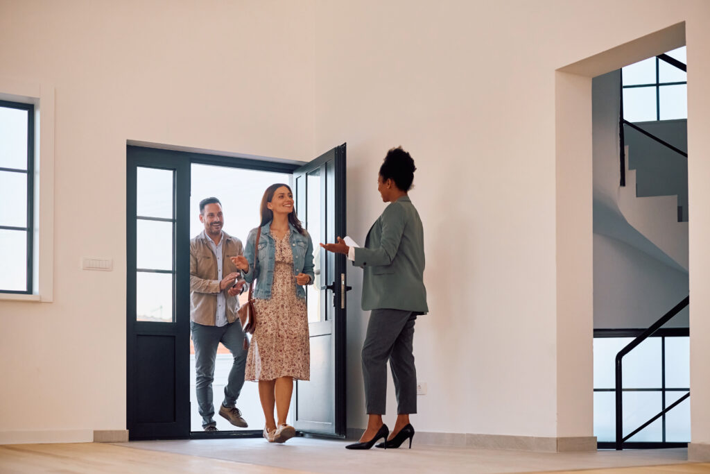 Real estate agent welcoming visitors at an open house